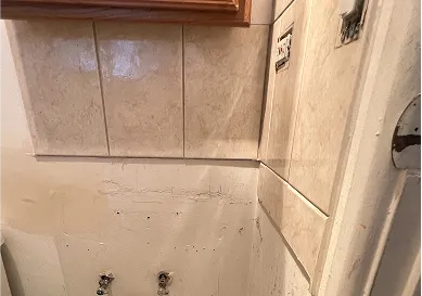 Cracked and aged bathroom tiles before reglazing