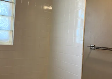 Shower tiles after reglazing with polished and renewed surface