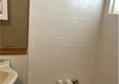 Shower tiles before reglazing with soap stains and dull texture