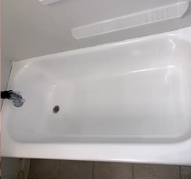 Glossy white bathtub professionally refinished for a refreshed bathroom